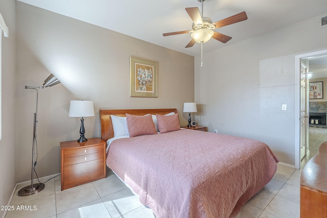 bedroom with baseboards, ceiling fan, light tile patterned flooring, and visible vents