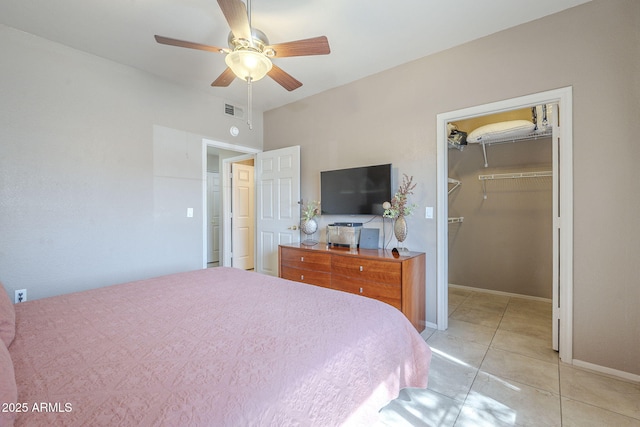 bedroom with ceiling fan, visible vents, a closet, a spacious closet, and light tile patterned flooring