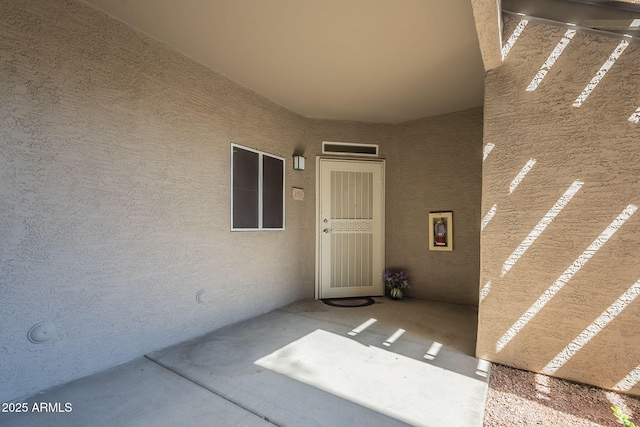 property entrance featuring stucco siding