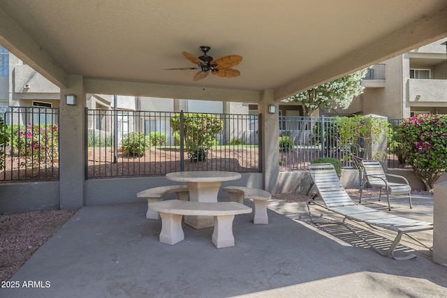 view of patio with a ceiling fan and fence