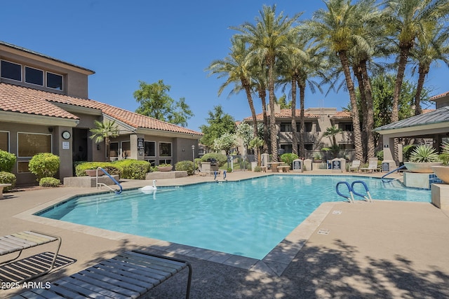 community pool with a patio and a gazebo