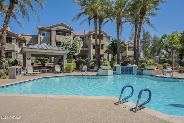 pool featuring a gazebo, fence, and a patio area