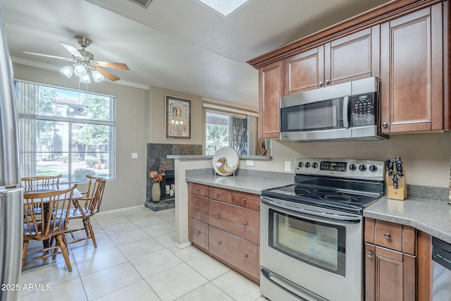 kitchen with stainless steel appliances, a ceiling fan, baseboards, light tile patterned floors, and ornamental molding