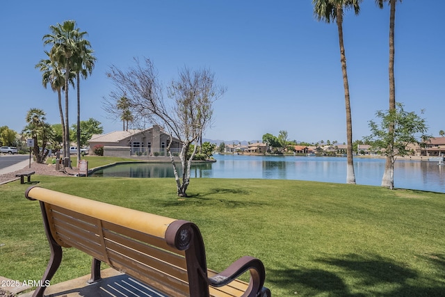 surrounding community with a water view, a yard, and a residential view