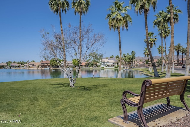 surrounding community featuring a yard, a water view, and a residential view
