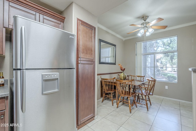 kitchen with stainless steel fridge, baseboards, ornamental molding, and a ceiling fan