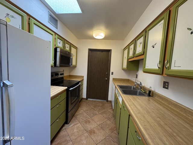kitchen featuring green cabinetry, appliances with stainless steel finishes, a sink, and visible vents
