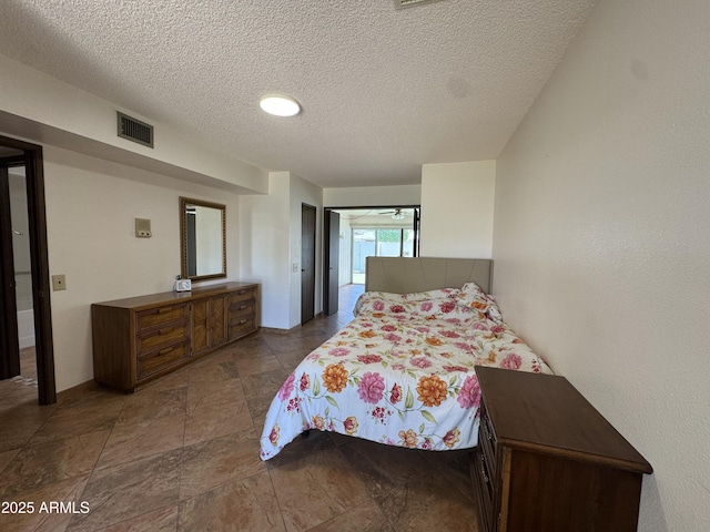 bedroom with visible vents and a textured ceiling