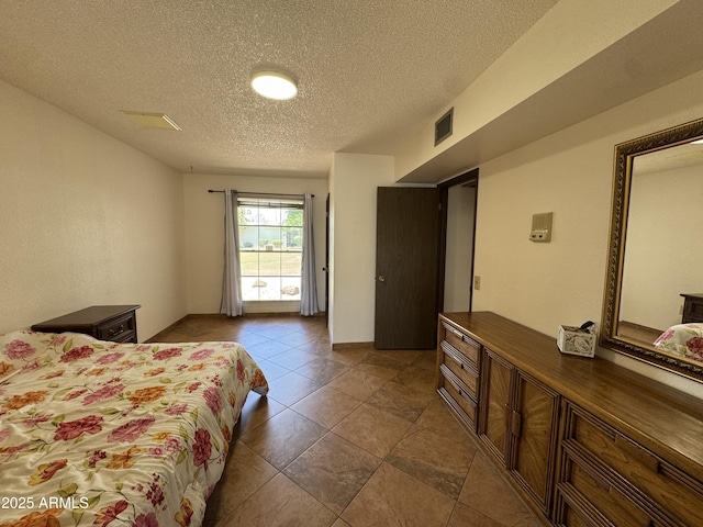 bedroom with visible vents and a textured ceiling