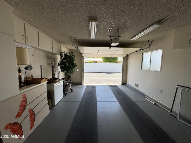 garage featuring visible vents and a garage door opener