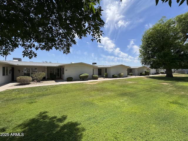 ranch-style home with a front lawn