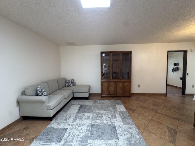 living area featuring visible vents and a textured ceiling
