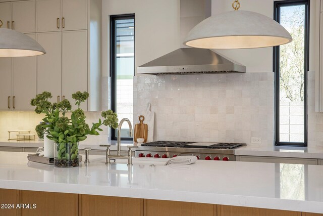 24779 N 91st St, Scottsdale, AZ 85255 - kitchen featuring wall chimney exhaust hood, tasteful backsplash, light countertops, stainless steel gas stovetop, and a sink