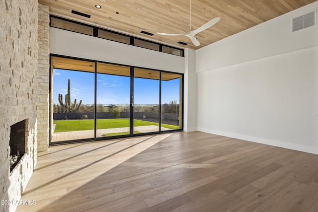 24779 N 91st St, Scottsdale, AZ 85255 - empty room with a towering ceiling, wood ceiling, a ceiling fan, wood finished floors, and a fireplace