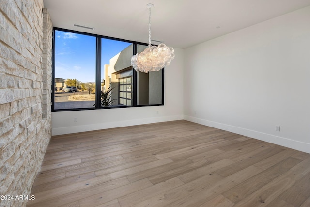 24779 N 91st St, Scottsdale, AZ 85255 - empty room featuring a chandelier, wood finished floors, and baseboards