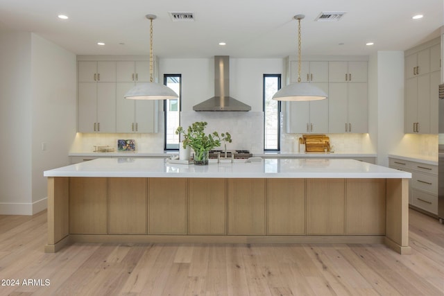 24779 N 91st St, Scottsdale, AZ 85255 - kitchen featuring wall chimney range hood, light countertops, backsplash, light wood-style floors, and recessed lighting