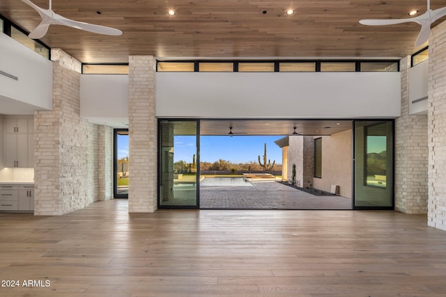 24779 N 91st St, Scottsdale, AZ 85255 - unfurnished living room featuring a ceiling fan, a high ceiling, healthy amount of natural light, wood ceiling, and hardwood / wood-style floors