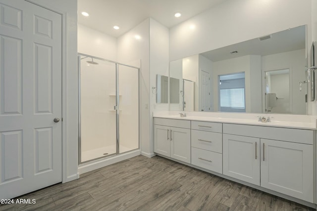 bathroom with vanity, wood-type flooring, and walk in shower