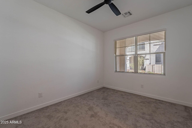 spare room featuring baseboards, visible vents, ceiling fan, and carpet flooring