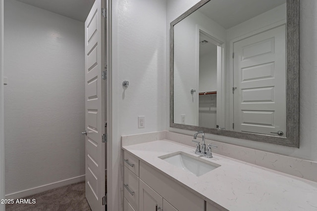 bathroom featuring vanity and baseboards