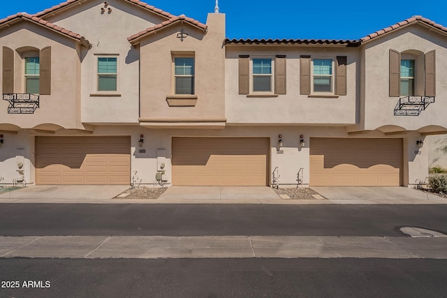 view of front of house with concrete driveway and stucco siding