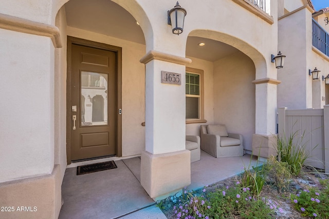 entrance to property with stucco siding