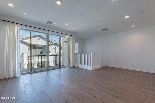 empty room with recessed lighting, visible vents, and wood finished floors