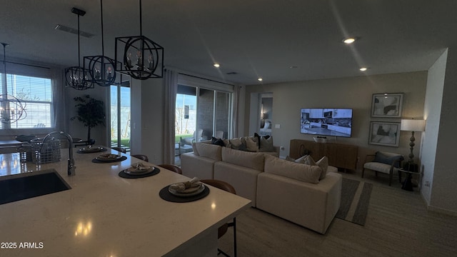 living room with sink and an inviting chandelier