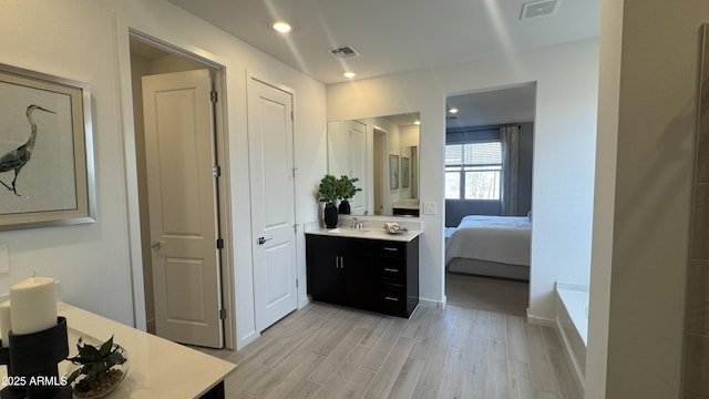 bathroom featuring vanity and hardwood / wood-style floors