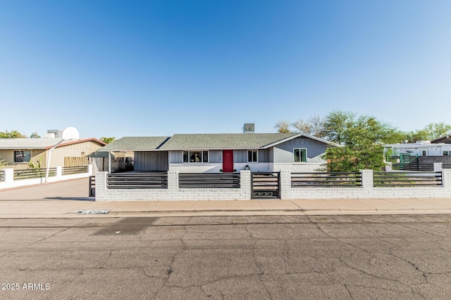 325 E Harmony Ave, Mesa, AZ 85210 - view of front facade featuring a fenced front yard, roof with shingles, and board and batten siding