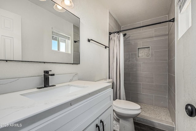 325 E Harmony Ave, Mesa, AZ 85210 - bathroom with vanity, a tile shower, and a textured ceiling