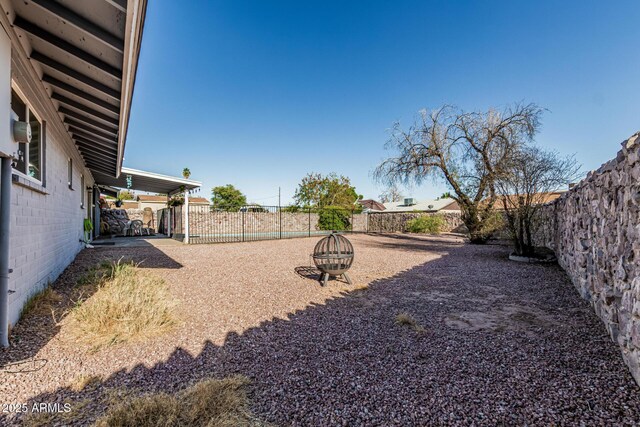 325 E Harmony Ave, Mesa, AZ 85210 - fenced backyard with an outdoor fire pit