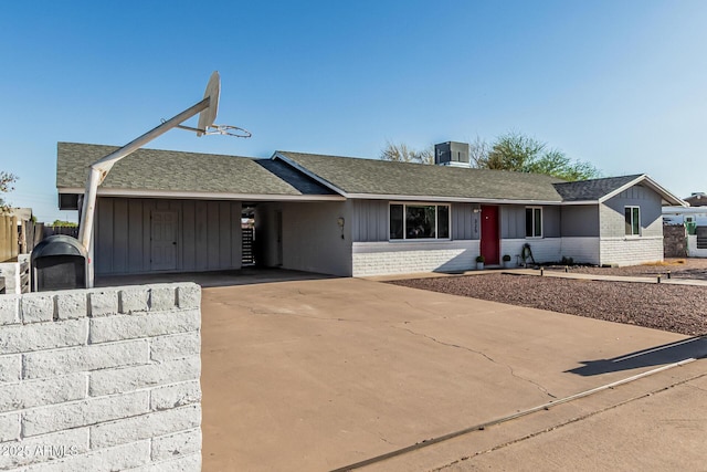 325 E Harmony Ave, Mesa, AZ 85210 - ranch-style house featuring brick siding, roof with shingles, board and batten siding, and concrete driveway