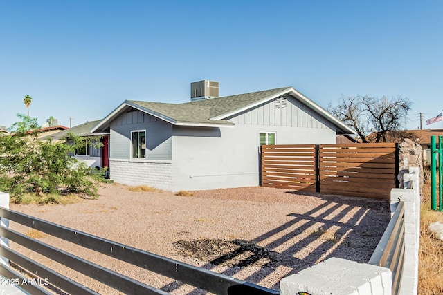 325 E Harmony Ave, Mesa, AZ 85210 - view of side of home with a shingled roof, brick siding, and board and batten siding