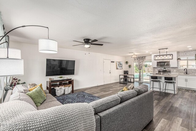 325 E Harmony Ave, Mesa, AZ 85210 - living room featuring dark wood finished floors, a textured ceiling, and ceiling fan
