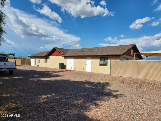 rear view of house featuring central AC