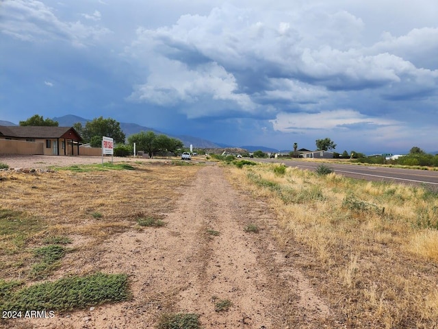 view of street with a rural view and a mountain view