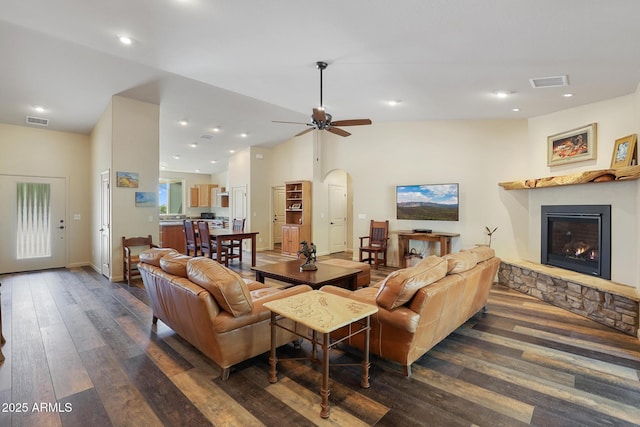 1604 W Beech Pkwy, Payson, AZ 85541 - living room with dark wood-type flooring, a stone fireplace, vaulted ceiling, arched walkways, and ceiling fan