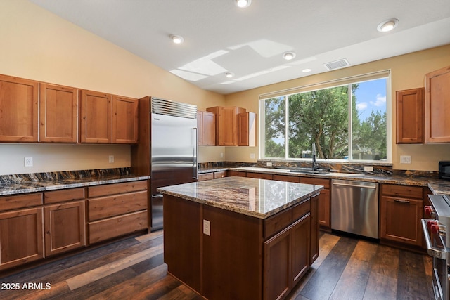 1604 W Beech Pkwy, Payson, AZ 85541 - kitchen with high quality appliances, dark wood-type flooring, dark stone counters, a center island, and brown cabinets