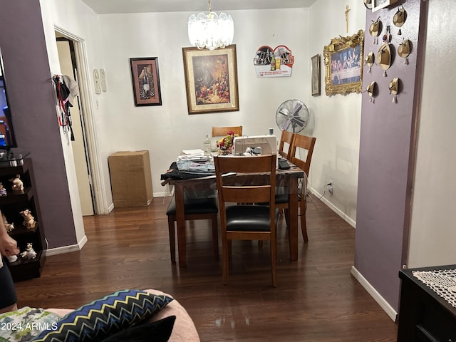 dining area with a notable chandelier and dark hardwood / wood-style floors