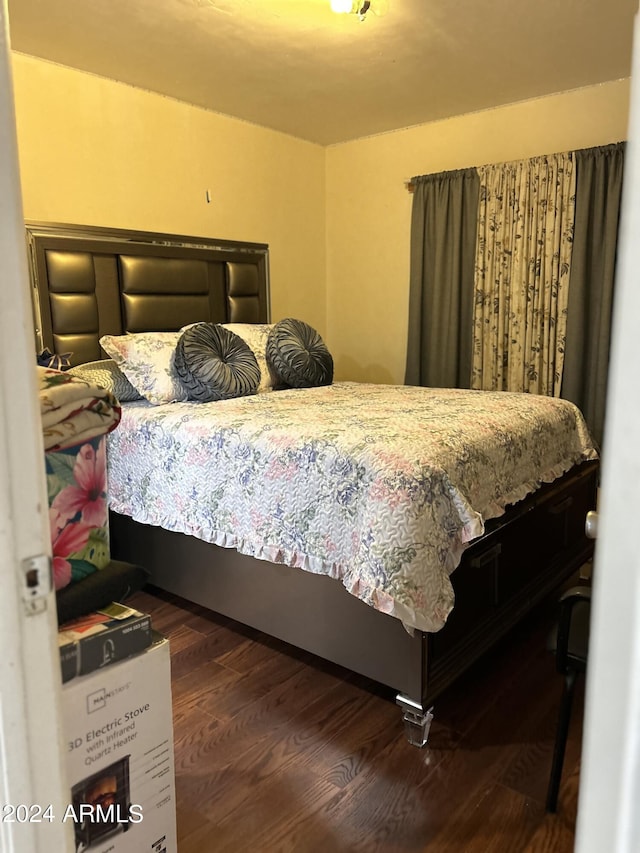 bedroom with dark wood-type flooring