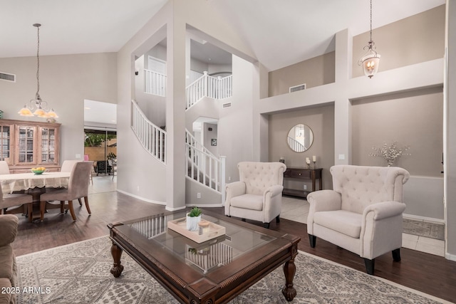 living area featuring visible vents, wood finished floors, and stairway