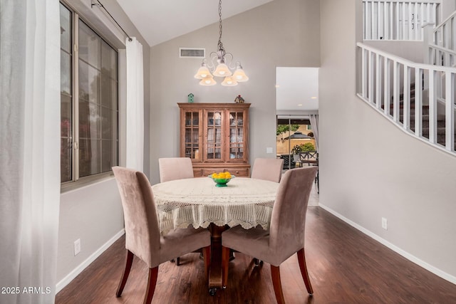 dining area with visible vents, high vaulted ceiling, dark wood finished floors, baseboards, and a chandelier