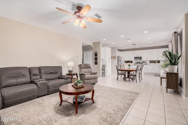 living area featuring light tile patterned floors, recessed lighting, visible vents, and ceiling fan