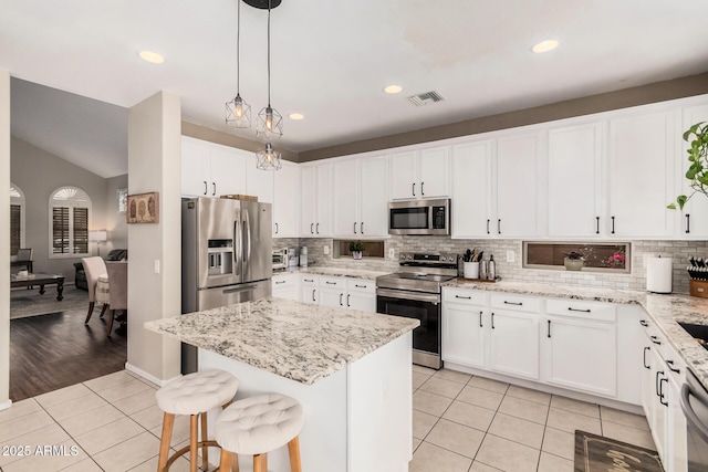 kitchen featuring white cabinets, light tile patterned floors, visible vents, and appliances with stainless steel finishes