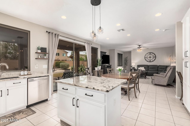 kitchen with ceiling fan, hanging light fixtures, stainless steel dishwasher, light tile patterned flooring, and a sink