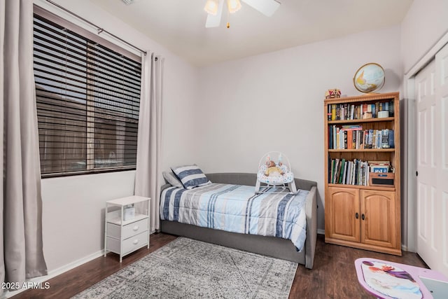 bedroom with baseboards, dark wood-type flooring, and ceiling fan