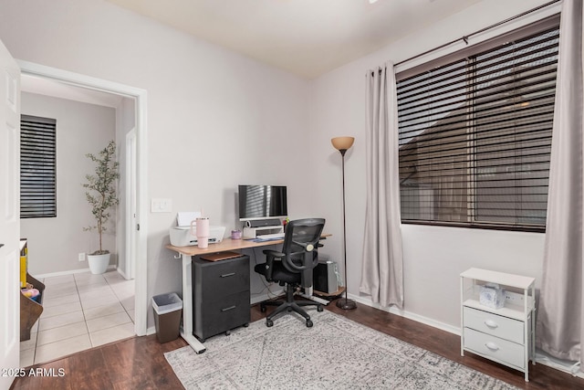 office space with baseboards and wood finished floors