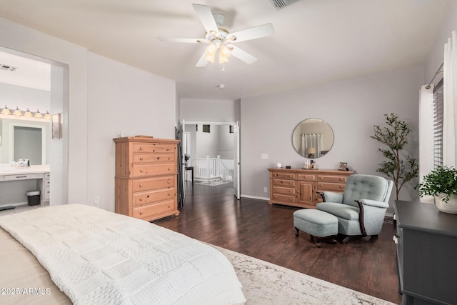 bedroom with a ceiling fan, dark wood-style floors, visible vents, and connected bathroom