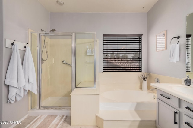 bathroom with a bath, a shower stall, tile patterned floors, and vanity